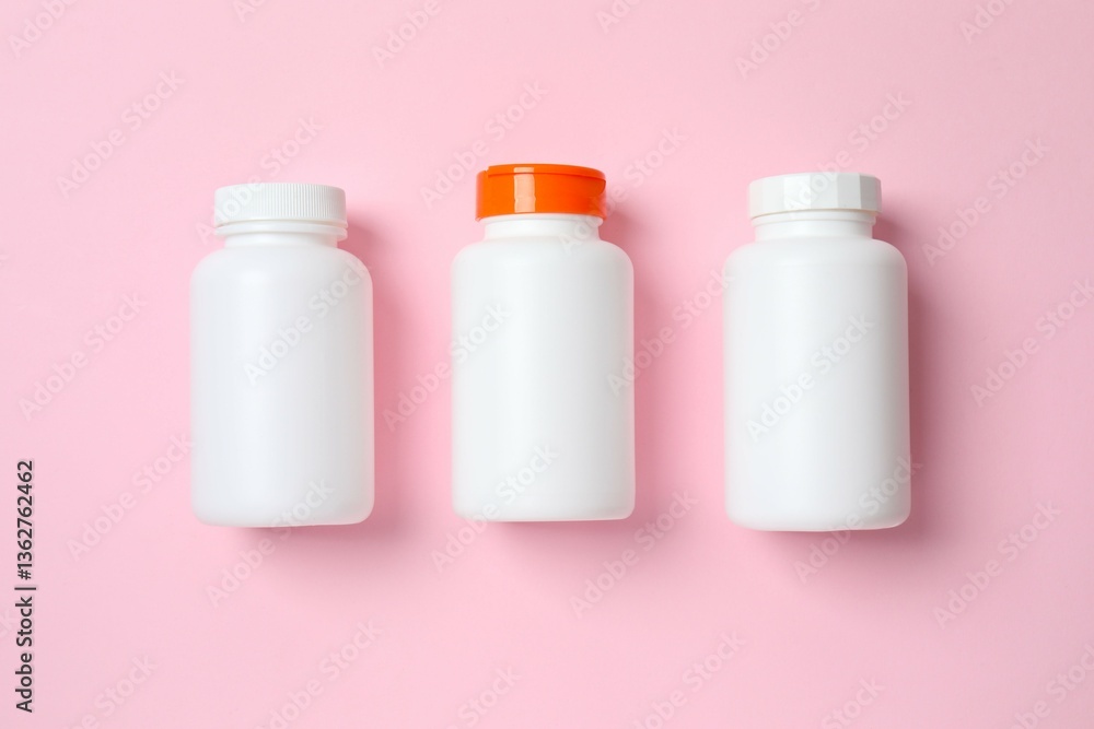 White bottles on color background, top view White bottles on color background, top view