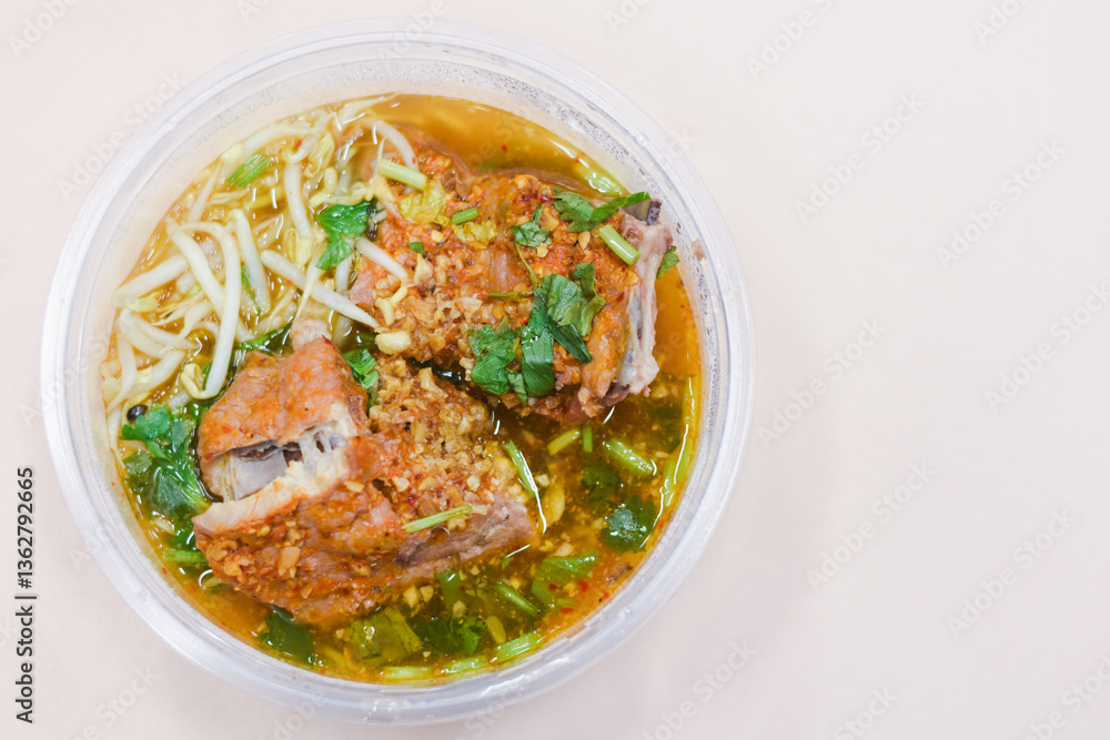 Pork tom yum noodles in a bowl on the table Pork tom yum noodles in a bowl on the table