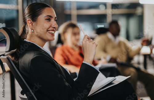 Valokuva A businesswoman actively participates in a team meeting