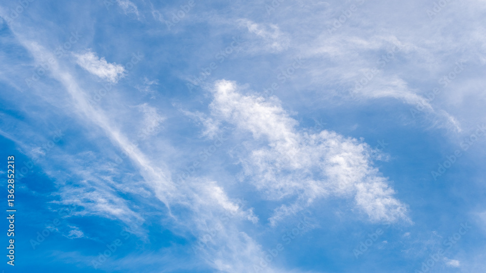 Serene blue sky featuring soft white clouds, creating a peaceful and tranquil atmosphere. Perfect for backgrounds, relaxation concepts, or environmental-themed designs. Serene blue sky featuring soft white clouds, creating a peaceful and tranquil atmosphere. Perfect for backgrounds, relaxation concepts, or environmental-themed designs.