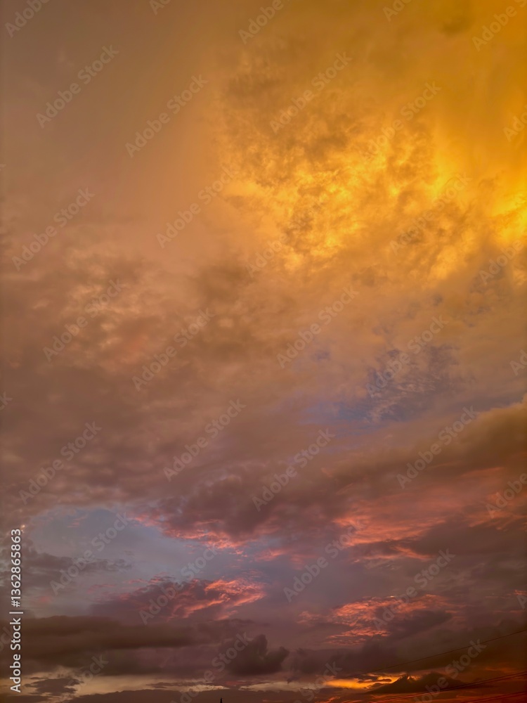 Fototapeta premium Beautiful sky with natural gradations. Thick clouds in the dusk sky on a winter night. Image of a cloudy sky in the afternoon. View of the night sky with golden light from the evening sun