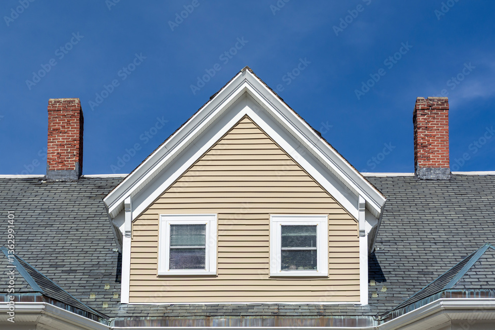 Prominent gable dormer with twin windows and brick chimneys on a historic home in Brighton, Massachusetts, USA
Prominent gable dormer with twin windows and brick chimneys on a historic home in Brighton, Massachusetts, USA