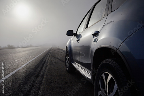 A car for traveling on a road with fog and sun