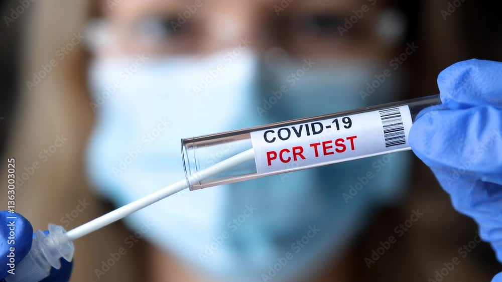 COVID-19 PCR test tube in hands of doctor, coronavirus swab collection kit close-up, corona virus concept