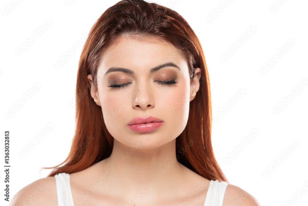 Fototapeta premium Serene woman with eyes closed, soft makeup, and smooth skin in white top, capturing a moment of tranquility and inner peace