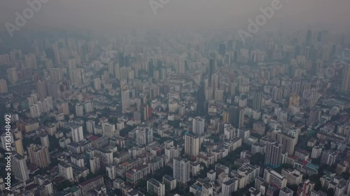 Wallpaper Mural Aerial video capturing a sprawling cityscape shrouded in fog, creating a mysterious and atmospheric mood. Wide-angle camera angle. Torontodigital.ca