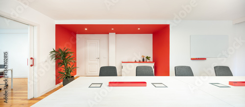Modern office meeting room with bold red accents