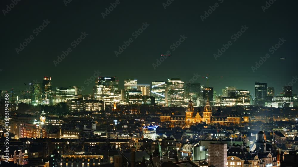 The illuminated skyline of Amsterdam's Zuidas district at night, featuring modern skyscrapers, corporate offices, and a dynamic financial hub blending contemporary architecture with urban vibrancy. The illuminated skyline of Amsterdam's Zuidas district at night, featuring modern skyscrapers, corporate offices, and a dynamic financial hub blending contemporary architecture with urban vibrancy.