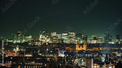 Wallpaper Mural The illuminated skyline of Amsterdam's Zuidas district at night, featuring modern skyscrapers, corporate offices, and a dynamic financial hub blending contemporary architecture with urban vibrancy. Torontodigital.ca