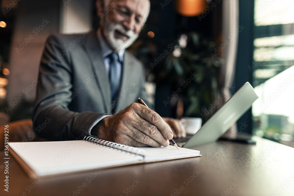 Senior Businessman Writing Notes at a Modern Café Window
