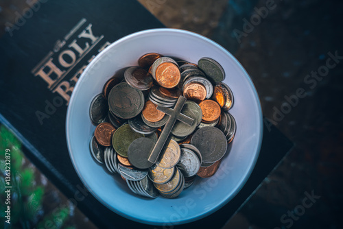 Coins with Holy Bible, a closeup, Christian biblical concept of tithing, Biblical concept of Christian offering