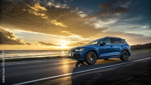Sleek blue SUV, dramatic sunset, golden sky, coastal road