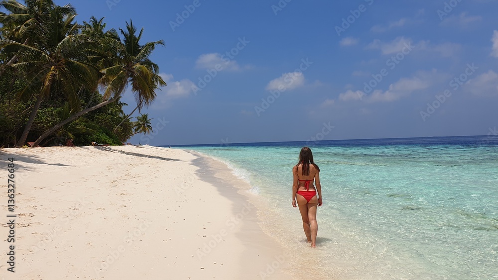 Woman in Red Bikini Walking on Paradise Beach in Maldives Woman in Red Bikini Walking on Paradise Beach in Maldives