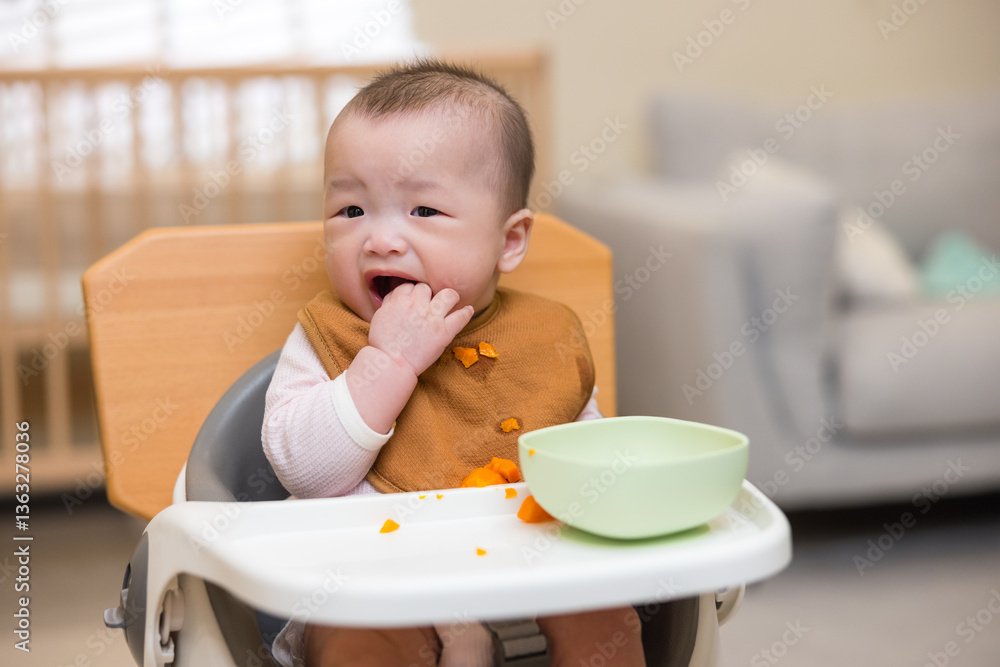 Happy Toddler Enjoying Carrot Snack At Home