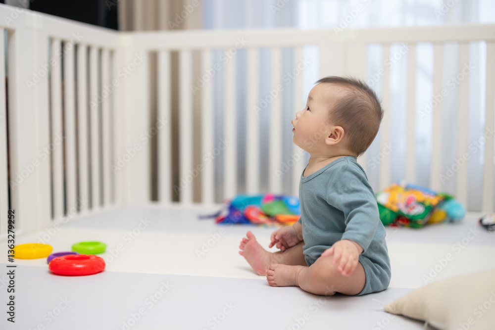 Little baby playing with toys in cozy crib Little baby playing with toys in cozy crib