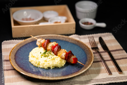 Typical czech cuisine chicken skewer with red pepper, onion, sausage and mashed potatoes