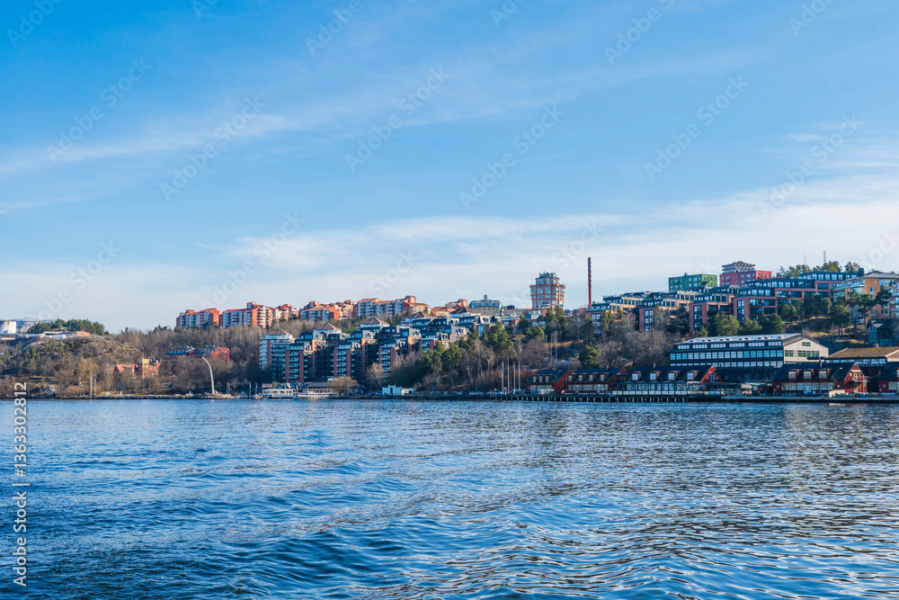 Obraz premium Apartment buildings in housing estate along embankment in Stockholm, Sweden