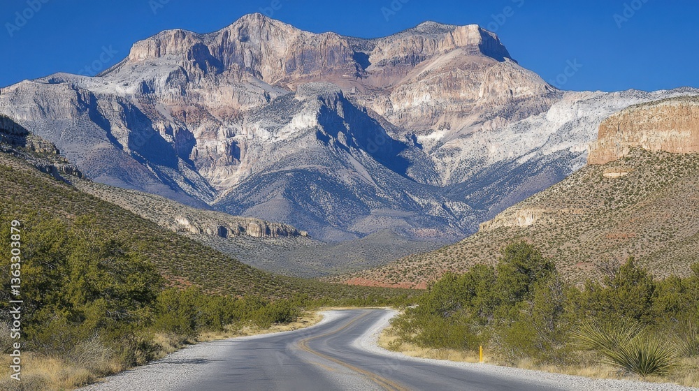 Fototapeta premium Scenic Mountain Landscape with Winding Road Under Clear Blue Sky in Nevada Desert Nature Adventure