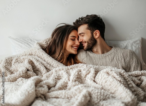 Couple Cuddling in Bed Under Blanket Enjoying Intimate Moment Together