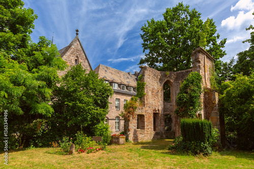 Stone ruins of historical church surrounded by greenery in the old town of Marburg Germany