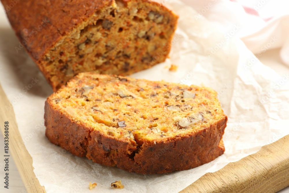 Cut homemade carrot cake with nuts on table, closeup Cut homemade carrot cake with nuts on table, closeup
