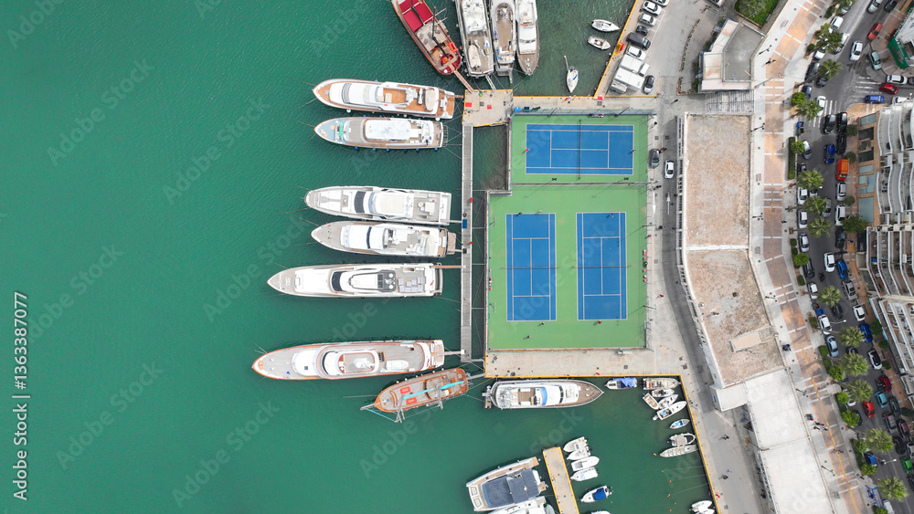 Aerial drone top view photo of tennis court built by waterfront inside port