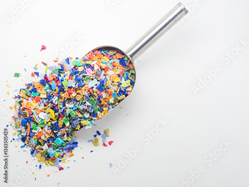 Foto Various colors of plastic waste that has been ground in a stainless shovel on a