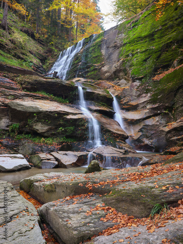 Autumn waterfall in a forest valley