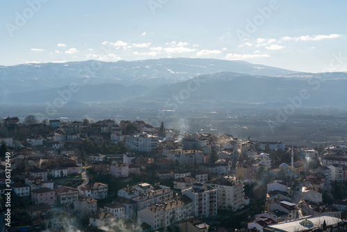 Panoramic View of a Valley Town with Mountain Backdrop
