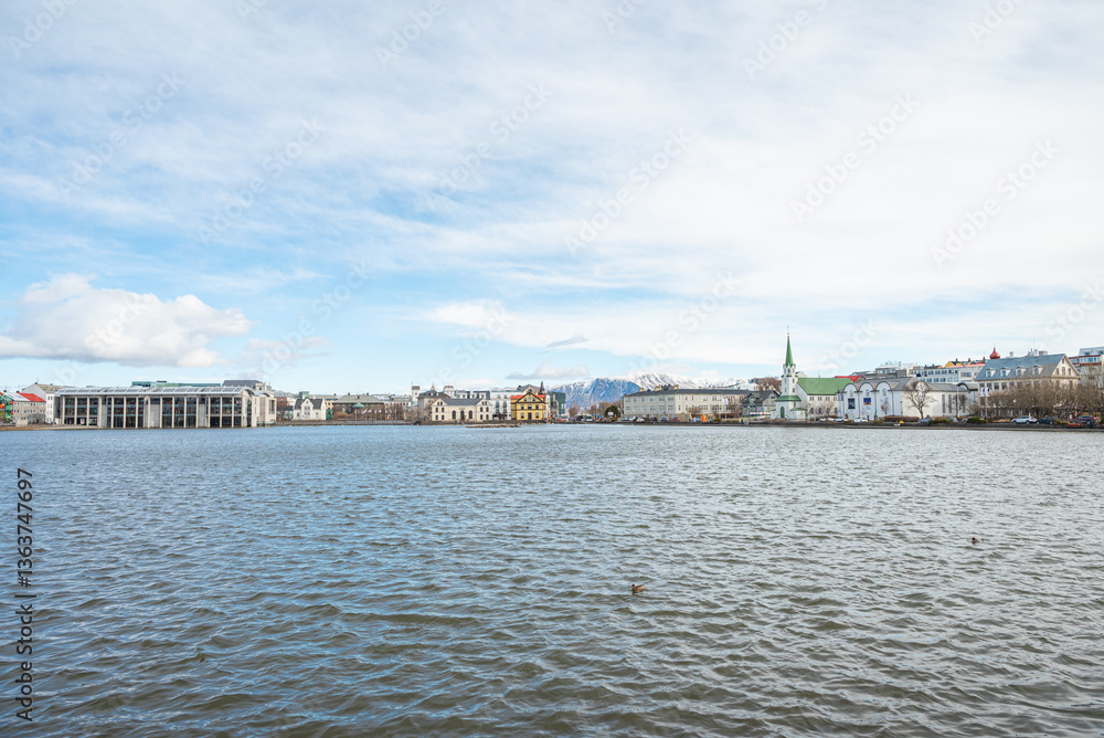Skyline by lake Tjornin in city of Reykjavik in Iceland Skyline by lake Tjornin in city of Reykjavik in Iceland