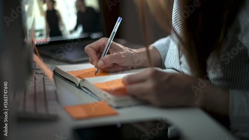 Crop woman writing in notepad