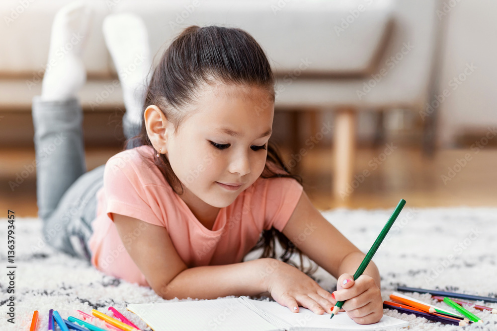 Cute Chinese Kid Sketching With Colorful Pencils Spending Weekend At Home, Lying On Floor. Little Artist Concept. Cute Chinese Kid Sketching With Colorful Pencils Spending Weekend At Home, Lying On Floor. Little Artist Concept.