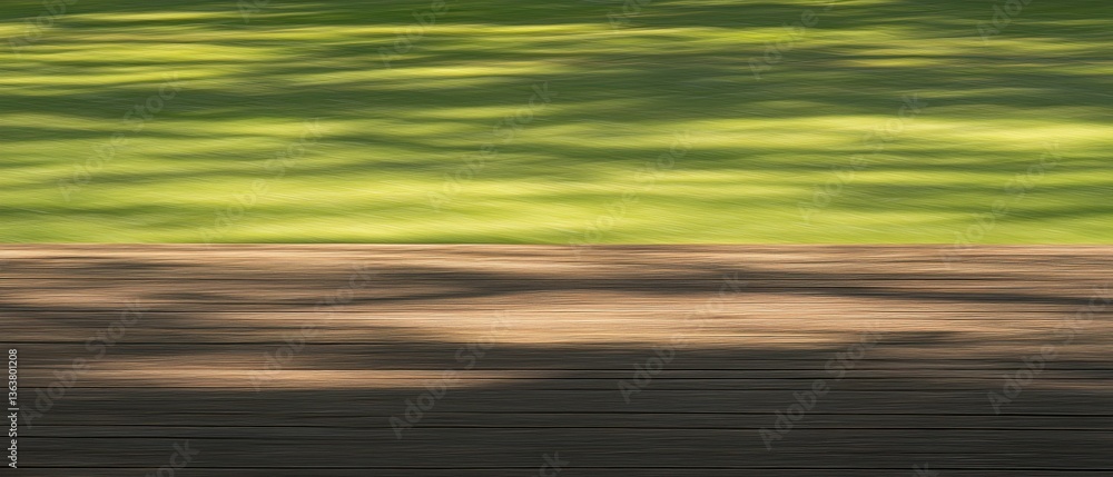 Obraz premium Shadows cast across the green grass and wooden surface