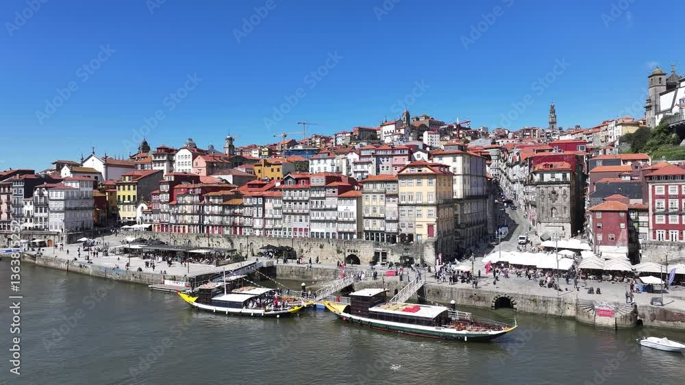 Ribeira Pier At Porto District Of Porto Portugal. Aerial View Of A Bustling City With High-Rise Buildings And Traffic. Business Clouds Sky Downtown Cityscape. Business Backgrounds Panoramic City. Ribeira Pier At Porto District Of Porto Portugal. Aerial View Of A Bustling City With High-Rise Buildings And Traffic. Business Clouds Sky Downtown Cityscape. Business Backgrounds Panoramic City.