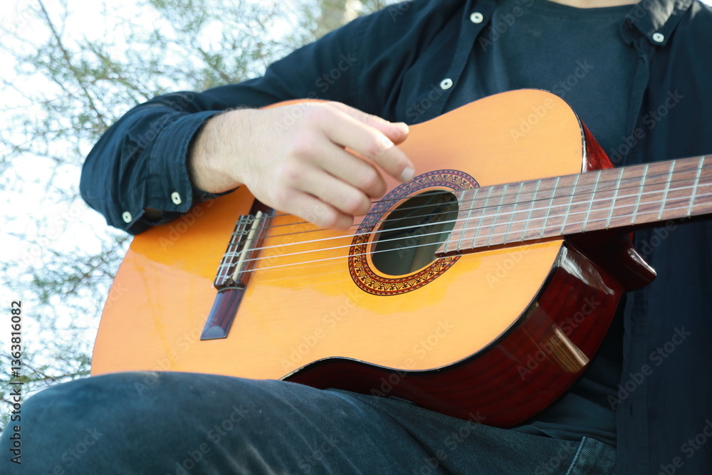 Fototapeta premium Playing the Guitar Outdoor to Train the Mind for Concentration and Exercise