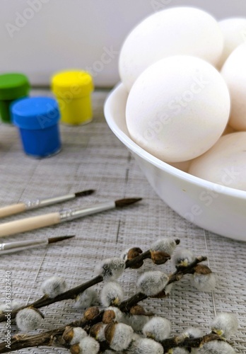 Chicken eggs in a bowl, paints, brushes, willow