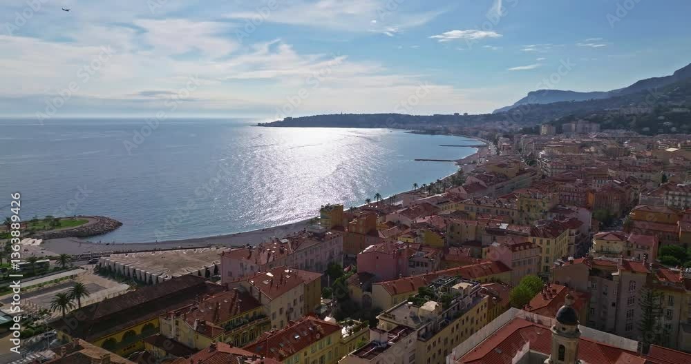 Aerial view of Menton, France. The colourful old town of Menton in summer, with historic buildings and beautiful beach at sunset. Aerial shot of historic church and colorful rooftops Aerial view of Menton, France. The colourful old town of Menton in summer, with historic buildings and beautiful beach at sunset. Aerial shot of historic church and colorful rooftops