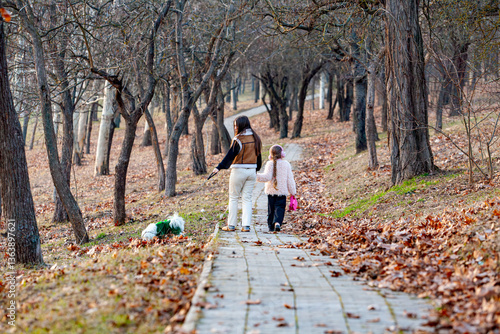 Canvas Print Pictures of two little girls while walking and playing with their white-collared dogs, they were the happiest and most joyful