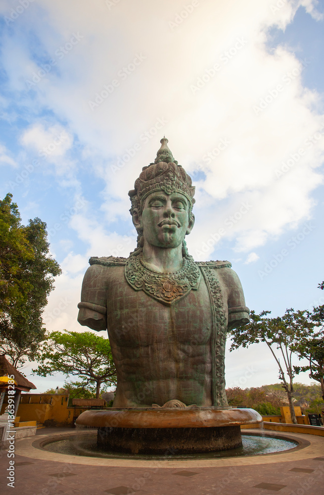 Half-body statue of Vishnu in the Garuda Wisnu Kencana complex in Bali Indonesia. In Hinduism, Vishnu is a god who is titled as shtiti, the maintainer of God's creation. Half-body statue of Vishnu in the Garuda Wisnu Kencana complex in Bali Indonesia. In Hinduism, Vishnu is a god who is titled as shtiti, the maintainer of God's creation.