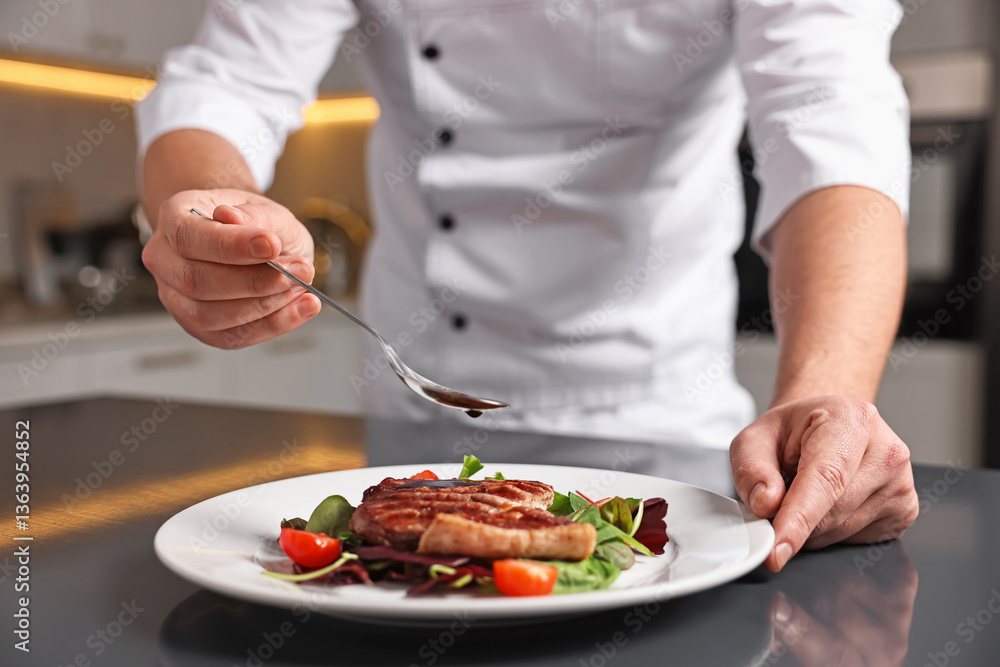 Professional chef adding sauce to delicious dish at table indoors, closeup Professional chef adding sauce to delicious dish at table indoors, closeup