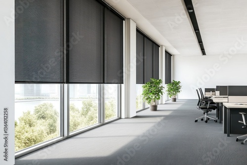 Modern office with black roller blinds, large windows, and desks.