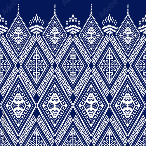 Traditional Geometric Pattern A seamless geometric pattern inspired by traditional textile designs, featuring diamond shapes, intricate line work, and symmetrical motifs in blue and white.