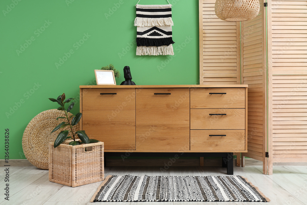 Obraz premium Interior of stylish living room with wooden folding screen and commode