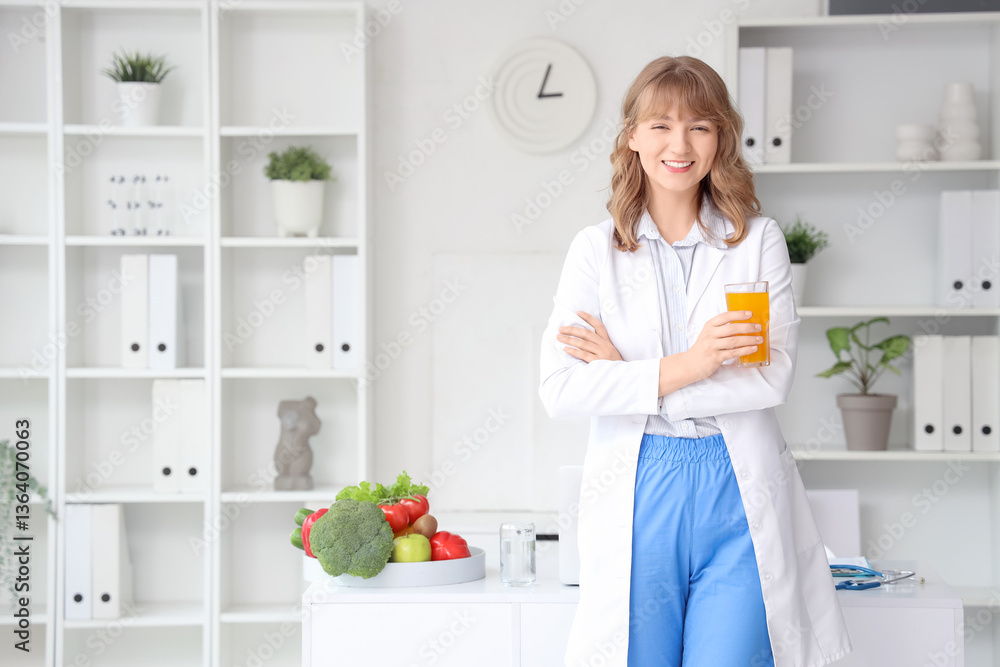 Female nutritionist with glass of juice in office Female nutritionist with glass of juice in office