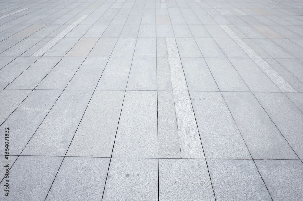 Grey brick stone street road. Light sidewalk, pavement texture. Granite outdoor tiled floor.