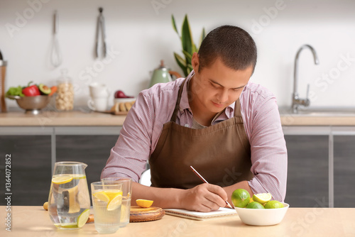 Young man with citrus fruit...