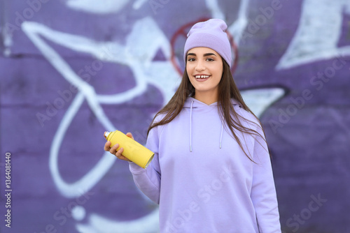 Teenage girl with spray pai...