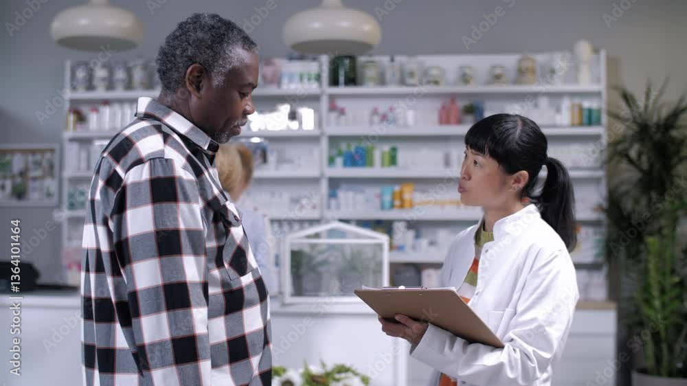 Pharmacist advising elderly man about medicine Pharmacist advising elderly man about medicine