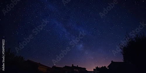 Fototapeta Naklejka Na Ścianę i Meble -  Starry sky with the Milky Way stretching over a quiet coastal village at night. 