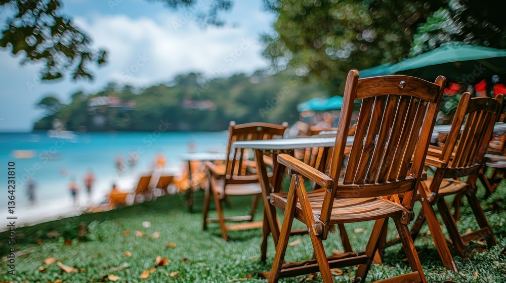 Fototapeta premium Beachside seating; wooden chairs face ocean. Turquoise water